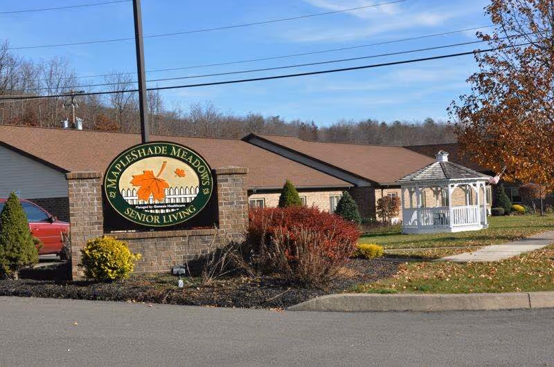 Sign reading 'Mapleshade Meadows Senior Living' in front of a single-story building with landscaping and a white gazebo.