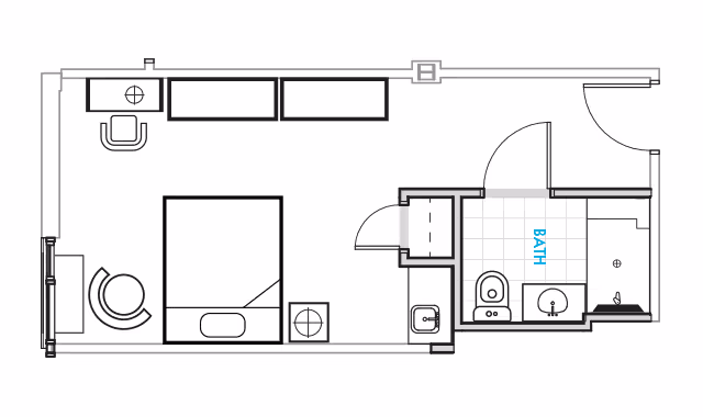 Black-and-white floor plan of a studio apartment showing a bed, seating area, kitchenette and a labeled bathroom.