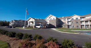 Exterior view of Northridge Gracious Retirement Living with entrance, parking, and landscaped grounds.