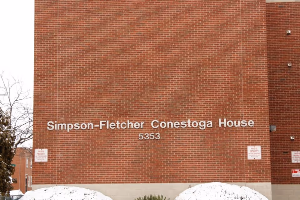Brick facade of Simpson-Fletcher Conestoga House with the address number 5353 and snow at the base.