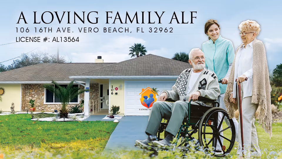 A single-story residential building with a lawn and a paved walkway leading to the entrance. In front of the building, an elderly man in a wheelchair is accompanied by a younger woman standing behind him and an elderly woman with a cane standing beside them. The building has a garage door with a colorful logo and the text 'A Loving Family ALF' above the entrance.