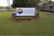 Outdoor lawn sign for Blue Ridge Healthcare Montgomery with a brick building in the background