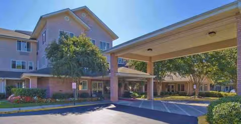 Exterior view of Washington Commons by Barclay House, with entrance canopy, brick building, and landscaping.
