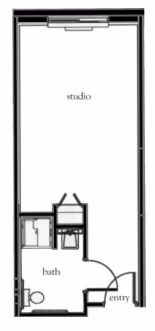 Floor plan of a studio apartment with an entry area, a bathroom including a toilet and shower, and a main studio living space.