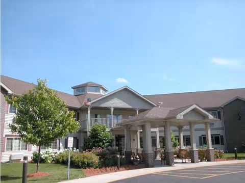 Front view of Miller's Senior Living Community building with entry porch and landscaping.