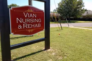 Red Vian Nursing and Rehab sign on a grassy lawn outside.