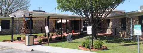 Exterior view of River Valley Health & Rehabilitation Center with covered walkway and landscaping.