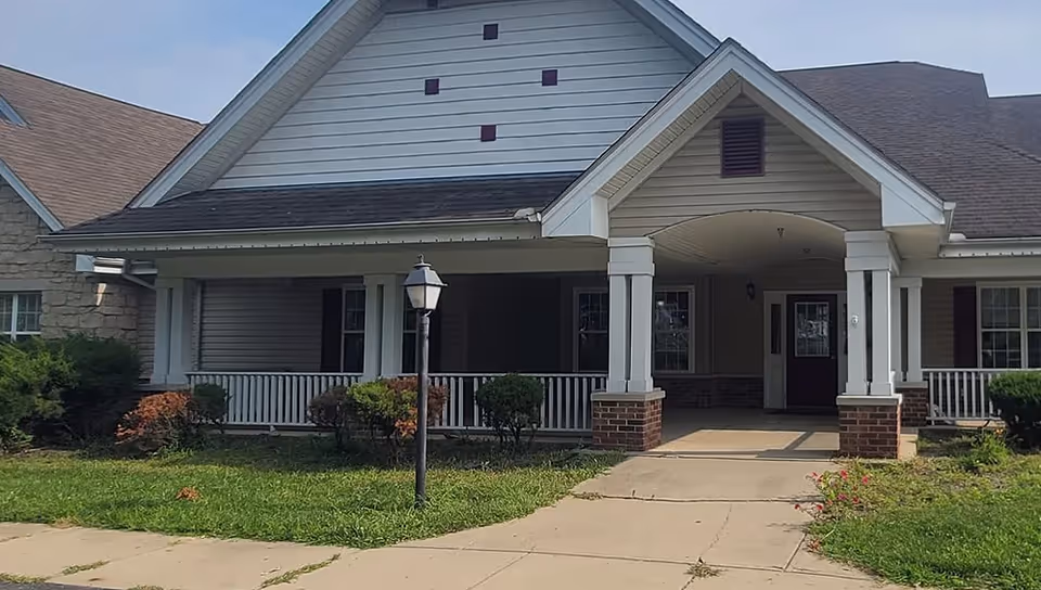 Front view of Aaron's Garden senior living facility with a covered entry and manicured lawn.