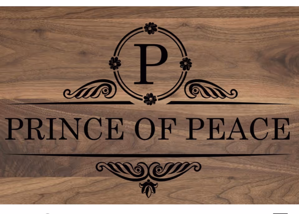 Wooden sign with circular logo and 'Prince of Peace' lettering on a wood background.