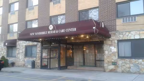 Exterior of New Vanderbilt Rehab & Care Center with burgundy entrance canopy.