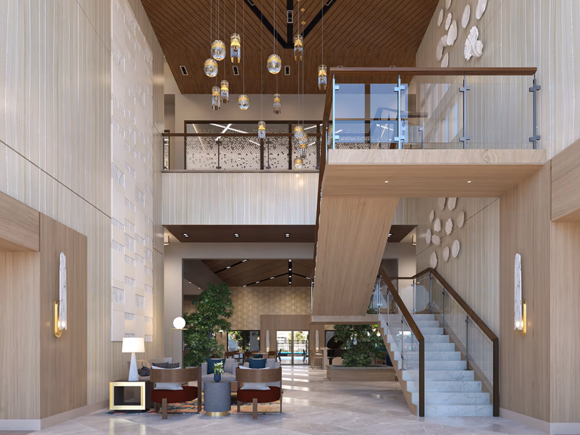 A spacious, modern interior of a senior living facility featuring a high ceiling with hanging pendant lights, a wooden staircase with glass railings leading to an upper level, comfortable seating areas with chairs and small tables, decorative wall art, and large potted plants. The space is well-lit with natural light coming through large windows in the background.