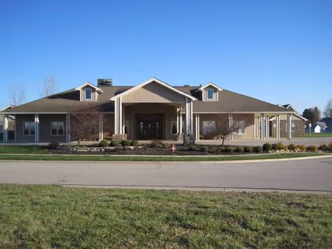Single-story senior living facility with a covered entrance and landscaped front yard.
