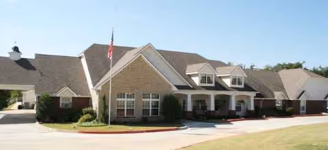 The Brookdale Ada senior living facility exterior features the front entrance and flagpole.