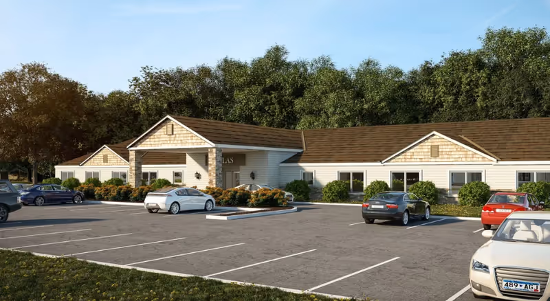 Atlas Villas Memory Care building exterior with a parking lot and landscaped entrance.