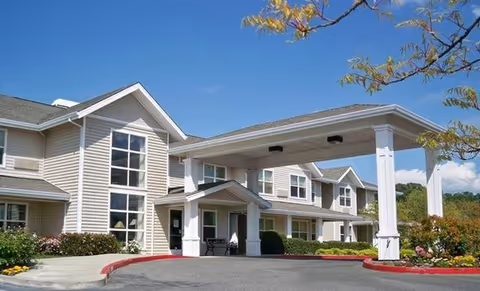 Exterior view of Marbella Oroville senior living facility with covered entrance