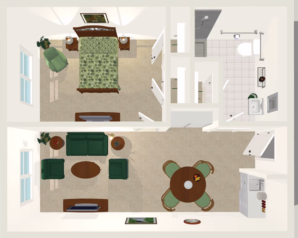 Top-down view of a senior living apartment floor plan showing a bedroom with a bed, two nightstands, a green armchair, and a dresser. Adjacent to the bedroom is a bathroom with a toilet, sink, and shower. The living area includes a green sofa, two armchairs, a coffee table, a round dining table with four chairs, and a kitchenette with a sink and counter space.