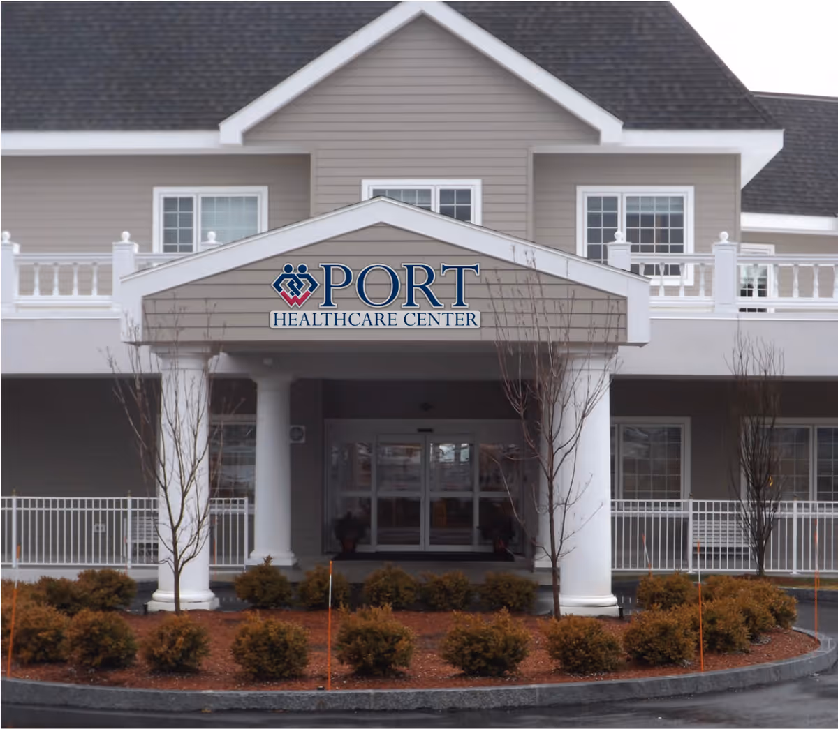 Front entrance of Port Healthcare Center with a covered portico, columns, and signage.
