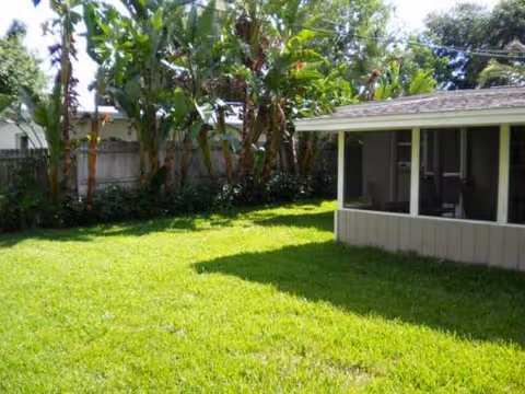Exterior yard of Norwood Assisted Living with a screened porch.
