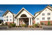 Front view of Presbyterian SeniorCare Network Southmont building with archway entrance and landscaping.
