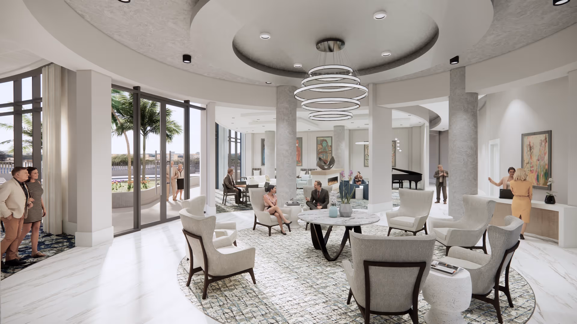 A spacious and modern senior living facility common area with a circular arrangement of beige armchairs around a round marble table on a patterned rug. Several people are seated and standing, engaging in conversation. Large floor-to-ceiling windows reveal palm trees and an outdoor patio area. The ceiling features a circular recessed design with contemporary ring-shaped light fixtures. Artwork and a grand piano are visible in the background.