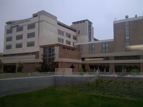 Exterior view of East Los Angeles Doctors Hospital with a multi-story beige facade and landscaping.