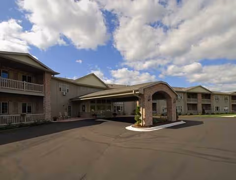 Exterior view of The Cottages on Golden Pond senior living entrance and building.