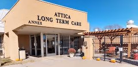 Exterior view of Attica Long Term Care Facility entrance with outdoor seating area.