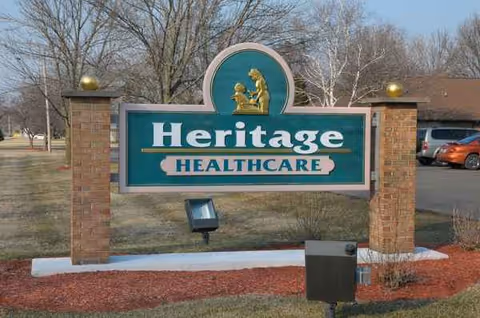 Heritage Healthcare sign on brick posts in front of a lawn