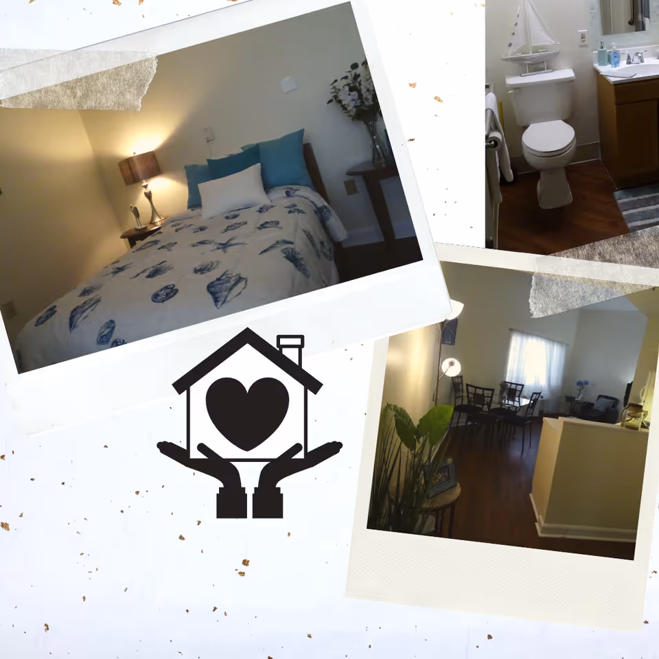 Collage of three photos showing interior views of a senior living facility. The top left photo shows a bedroom with a bed covered in a seashell-patterned comforter, a bedside table with a lamp, and decorative pillows. The top right photo shows a bathroom with a toilet, sink, and a small sailboat decoration on the toilet tank. The bottom right photo shows a dining and living area with a dining table and chairs, a floor lamp, some plants, and a seating area with a window letting in natural light. In the center of the collage is a graphic of a house with a heart inside, held by two hands.