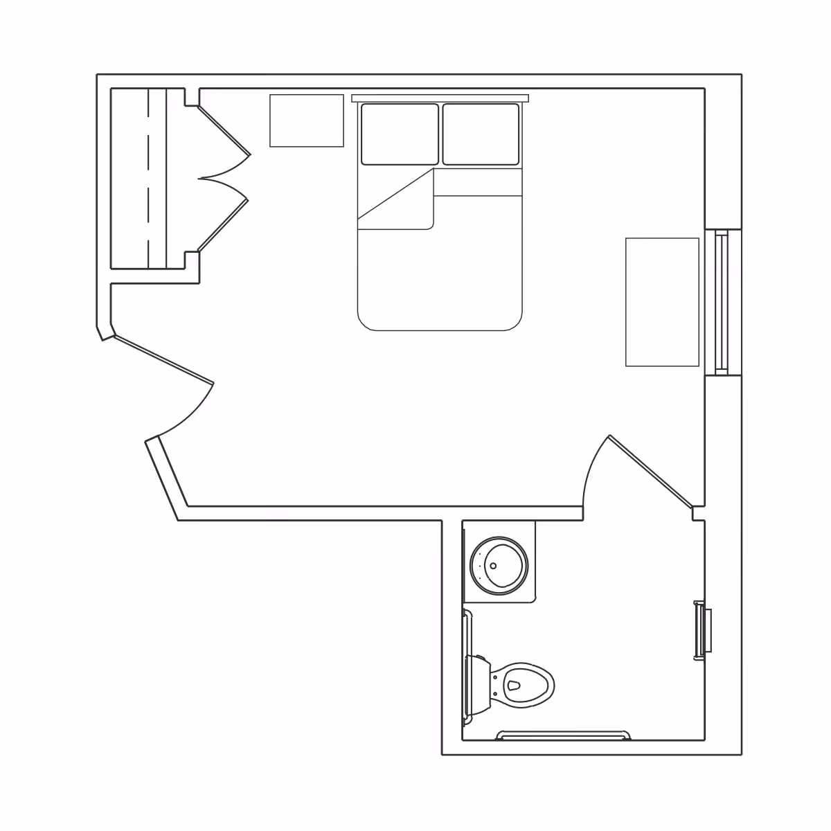 Architectural floor plan of a small living space featuring a bedroom with a double bed, a closet, a desk, and an attached bathroom with a toilet and sink.