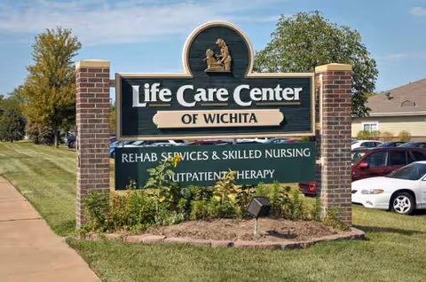 Exterior sign reads Life Care Center of Wichita with brick pillars and landscaped yard.
