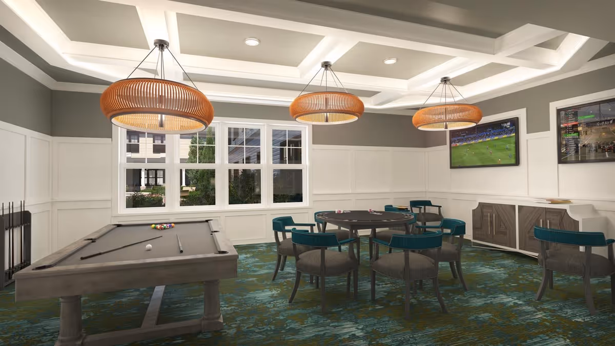 A recreational room with a pool table and a round card table surrounded by chairs. The room has large windows, three modern pendant lights hanging from a coffered ceiling, and two flat-screen TVs mounted on the wall. The floor is covered with a patterned carpet, and there is a sideboard against one wall.