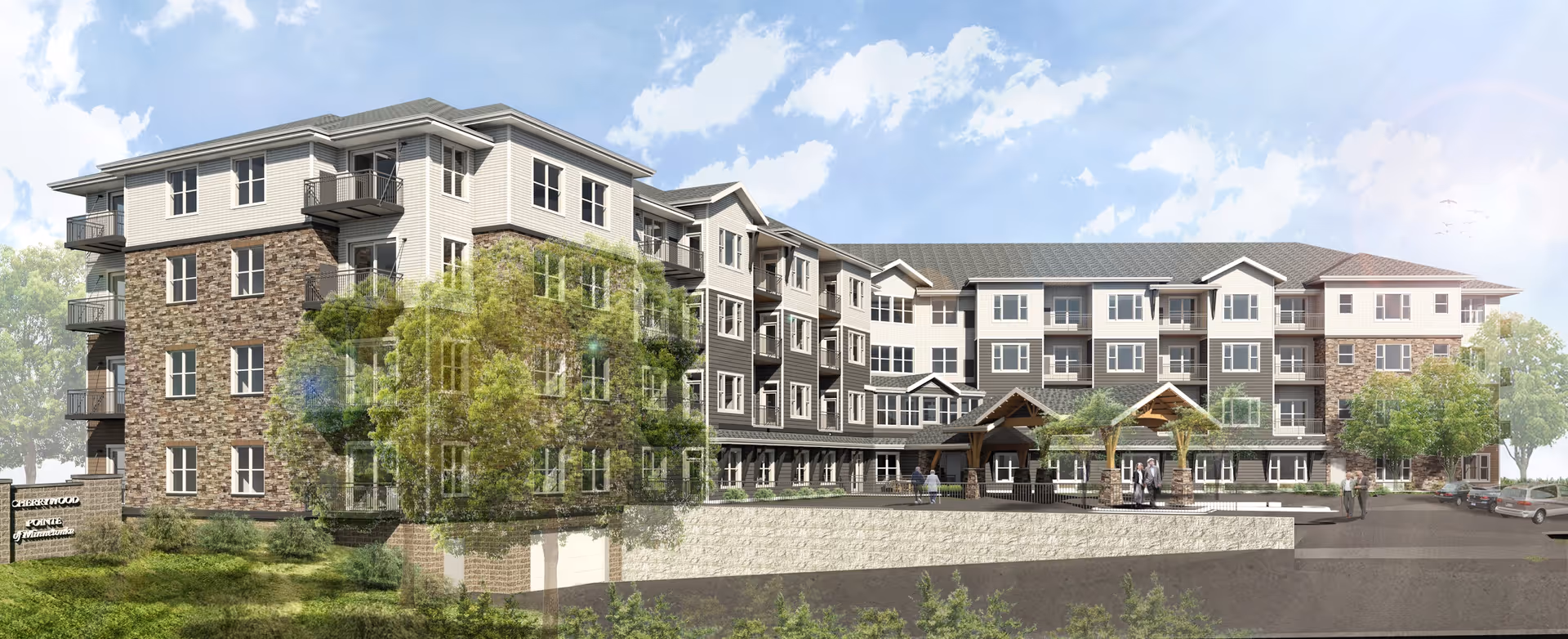 Front exterior of a multi-story senior living building with stone and siding, landscaped grounds, and a covered main entrance.