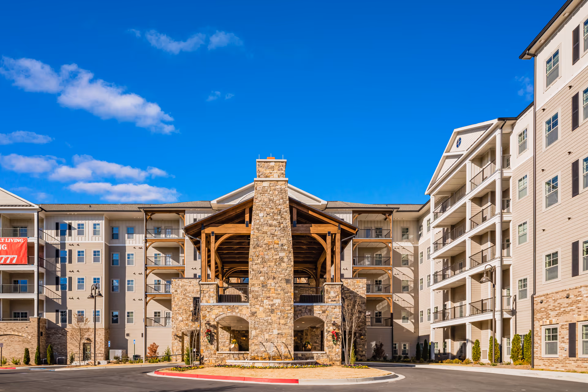 Exterior view of Holbrook Acworth senior living campus with a stone central pavilion.