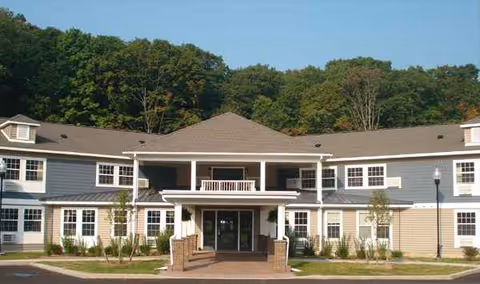 Front exterior view of Mountain Valley Manor Adult Home with entrance and landscaping.