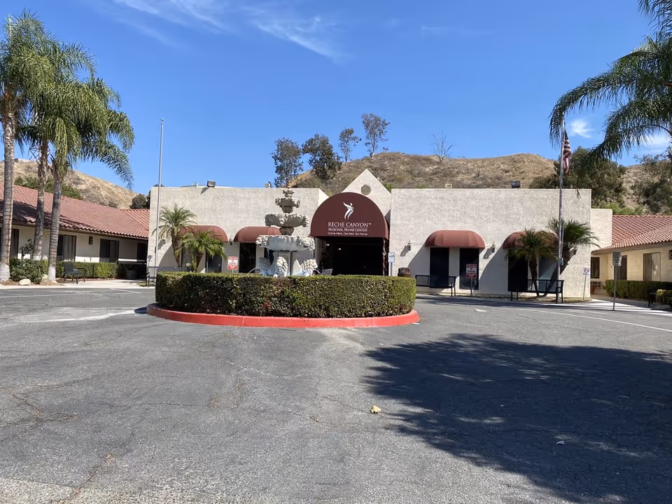 Exterior view of Reche Canyon Regional Rehab Center with fountain and palm trees