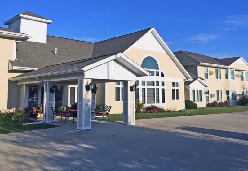 Meadow Ridge Senior Living building with a covered front entrance and benches