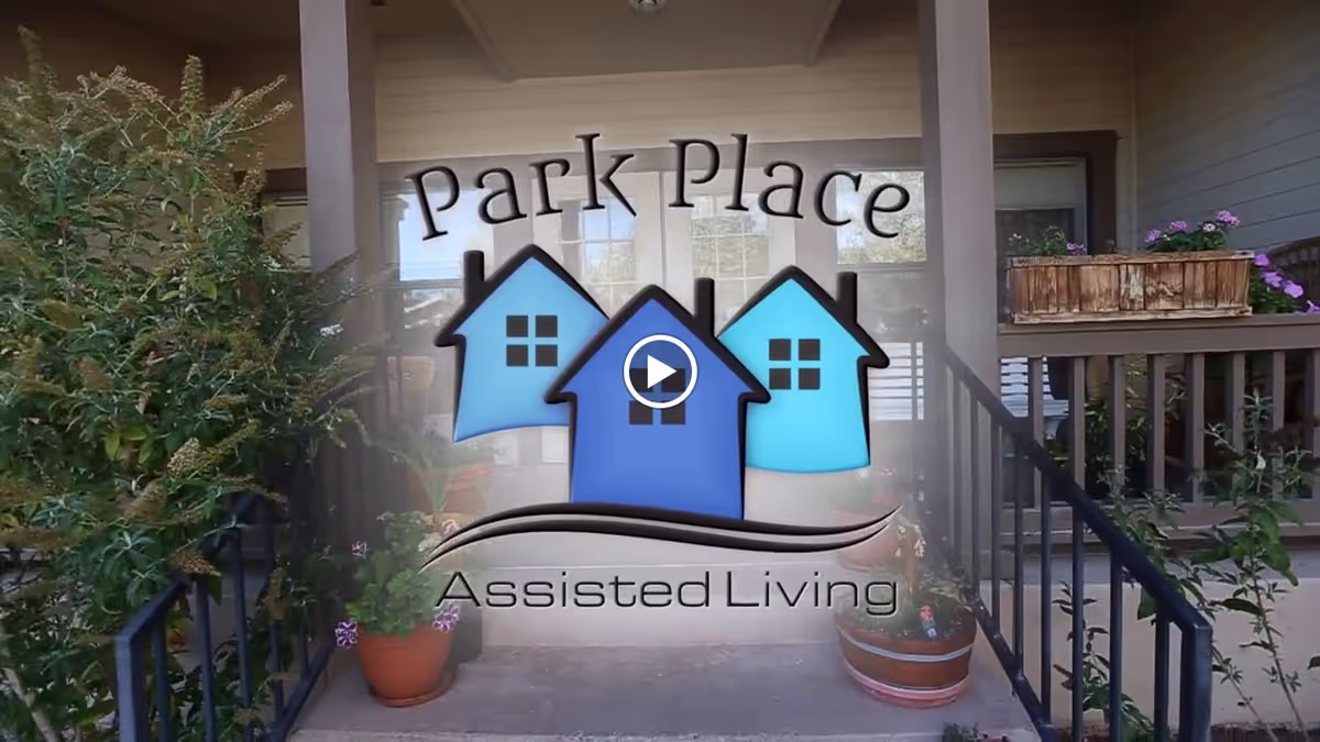 Entrance porch of Park Place Assisted Living with railings, potted plants, and an overlaid logo.