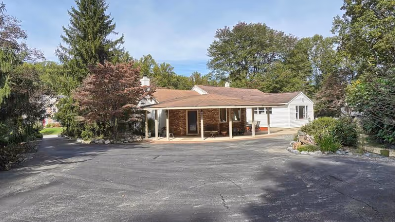 Exterior view of Advent Home Assisted Living showing a single-story building with a front porch.