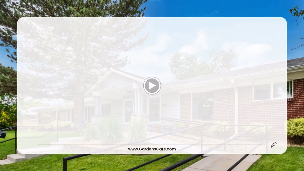 Front exterior of a single-story senior living building with a brick facade, entry ramp, lawn and trees.