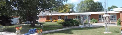 Lutheran Retirement Home exterior: a single-story brick building with lawn and walkway.