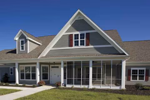 Exterior view of The Cottages at Garden Grove with a covered porch and gabled roof.