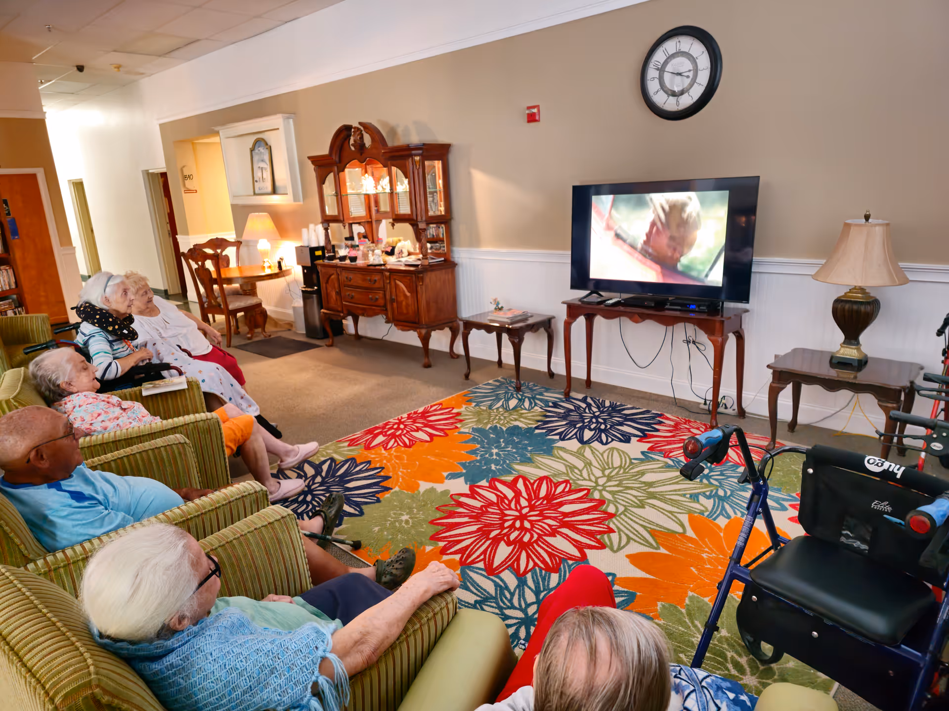 Seniors watching television in a cozy living room setting.