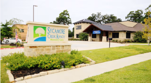 Front exterior of Sycamore Creek Ranch at Cypresswood with sign and entrance.