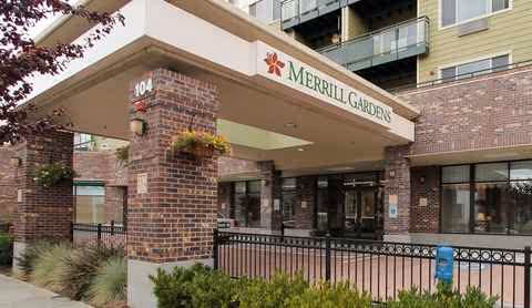 Brick entrance of Merrill Gardens at Renton Centre with a covered drop-off and sign.