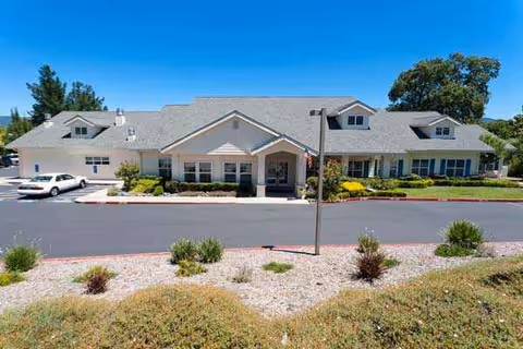 Front exterior view of Mountain View Assisted Living & Memory Care building with a parking lot.