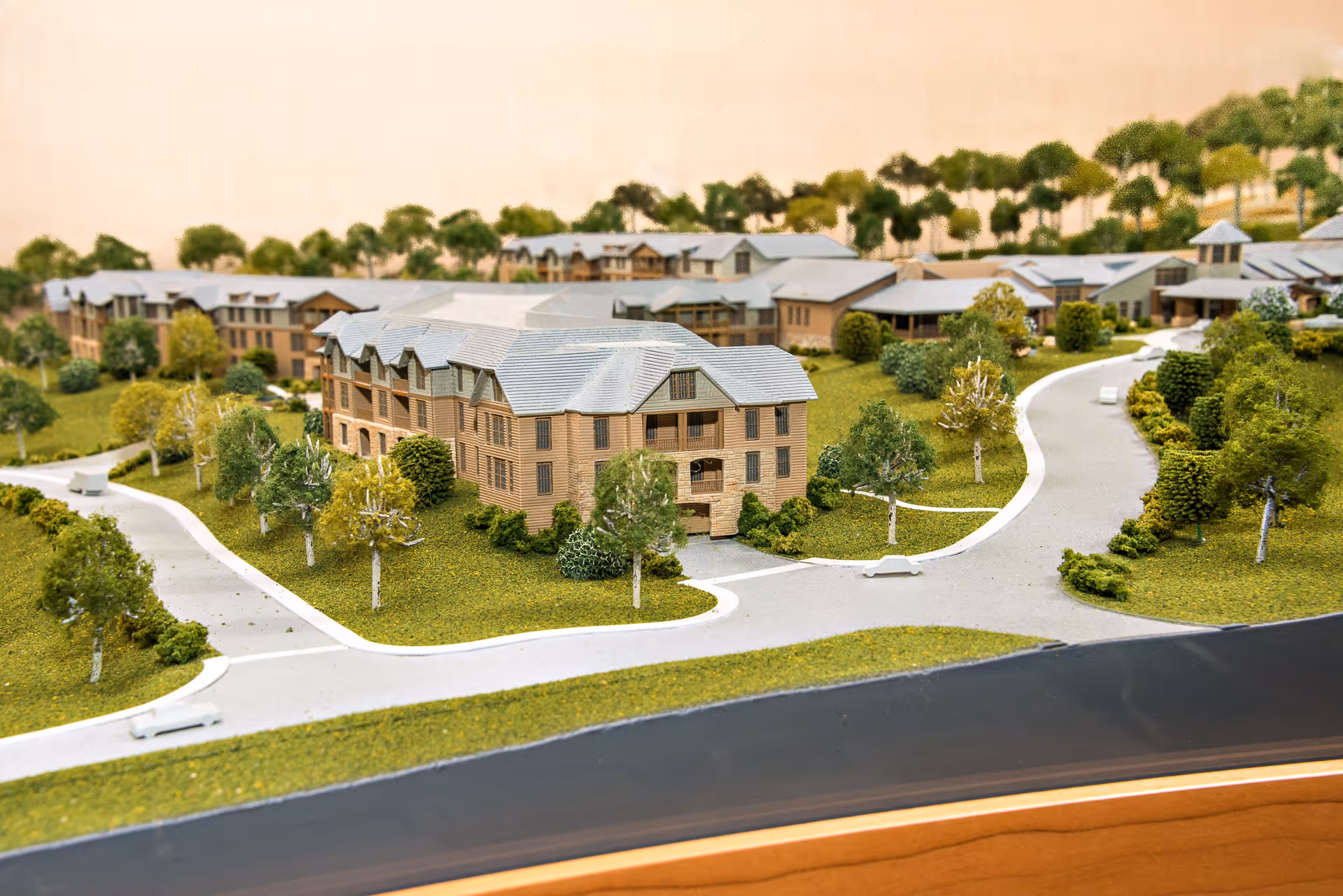 A detailed architectural scale model of the Christian Health Care Center campus, showing multiple buildings with gray roofs surrounded by green landscaping, trees, and winding roads.