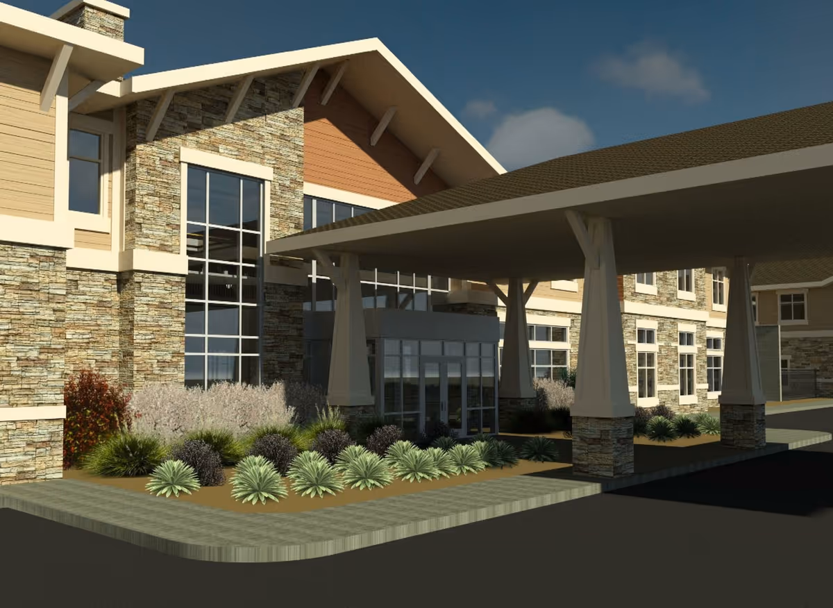 Exterior view of Crescent Senior Living building showing a covered entrance with stone and wood siding, large windows, and landscaped plants in front.