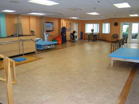 Wide view of a rehabilitation area with exercise equipment inside Apple Rehab West Haven.