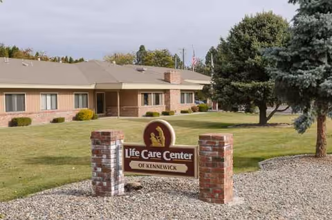 Front view of Life Care Center of Kennewick with sign and manicured lawn.